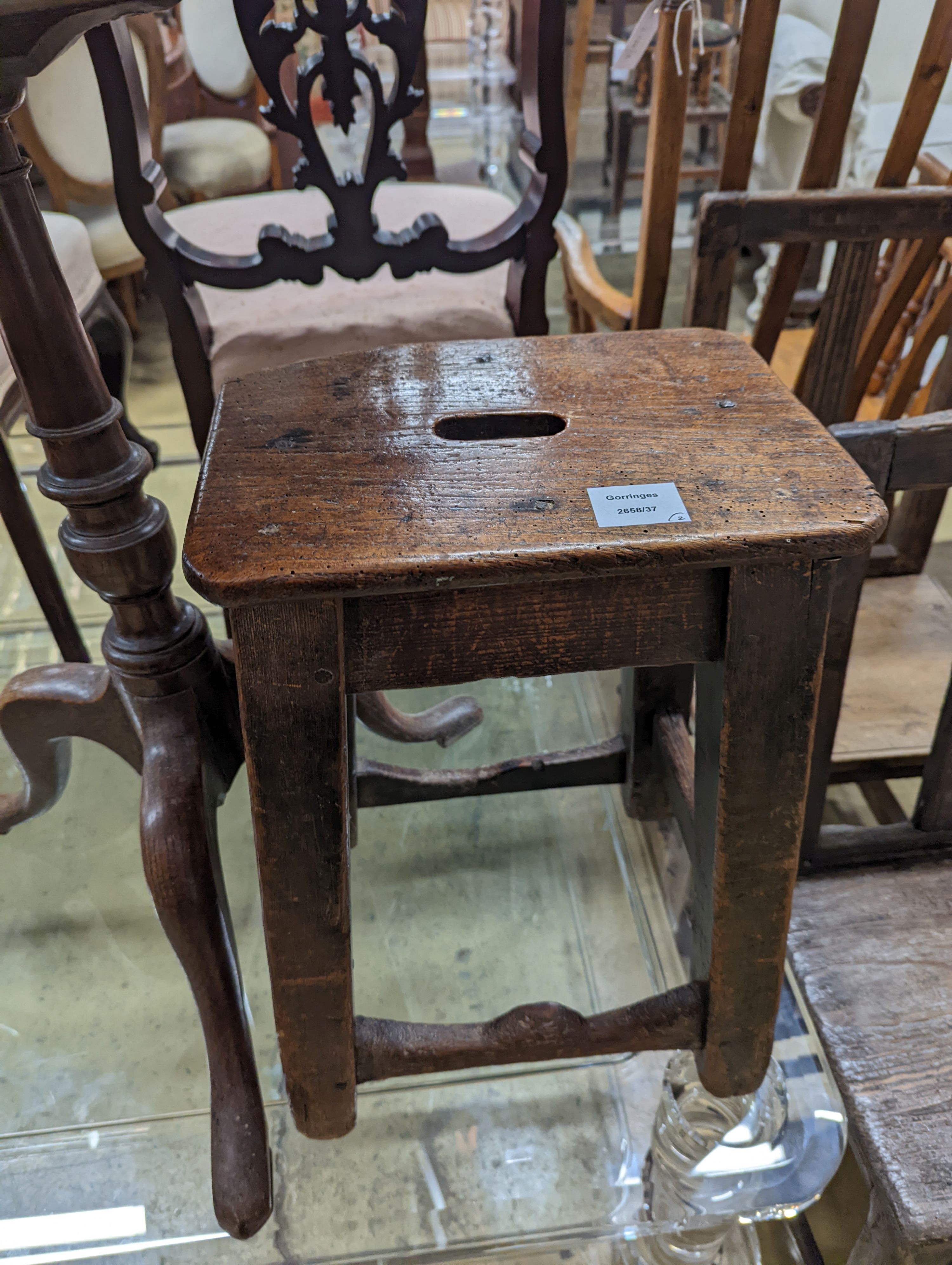 A 19th century oak stool and an oak tripod table, table diameter 53cm, 70cm height